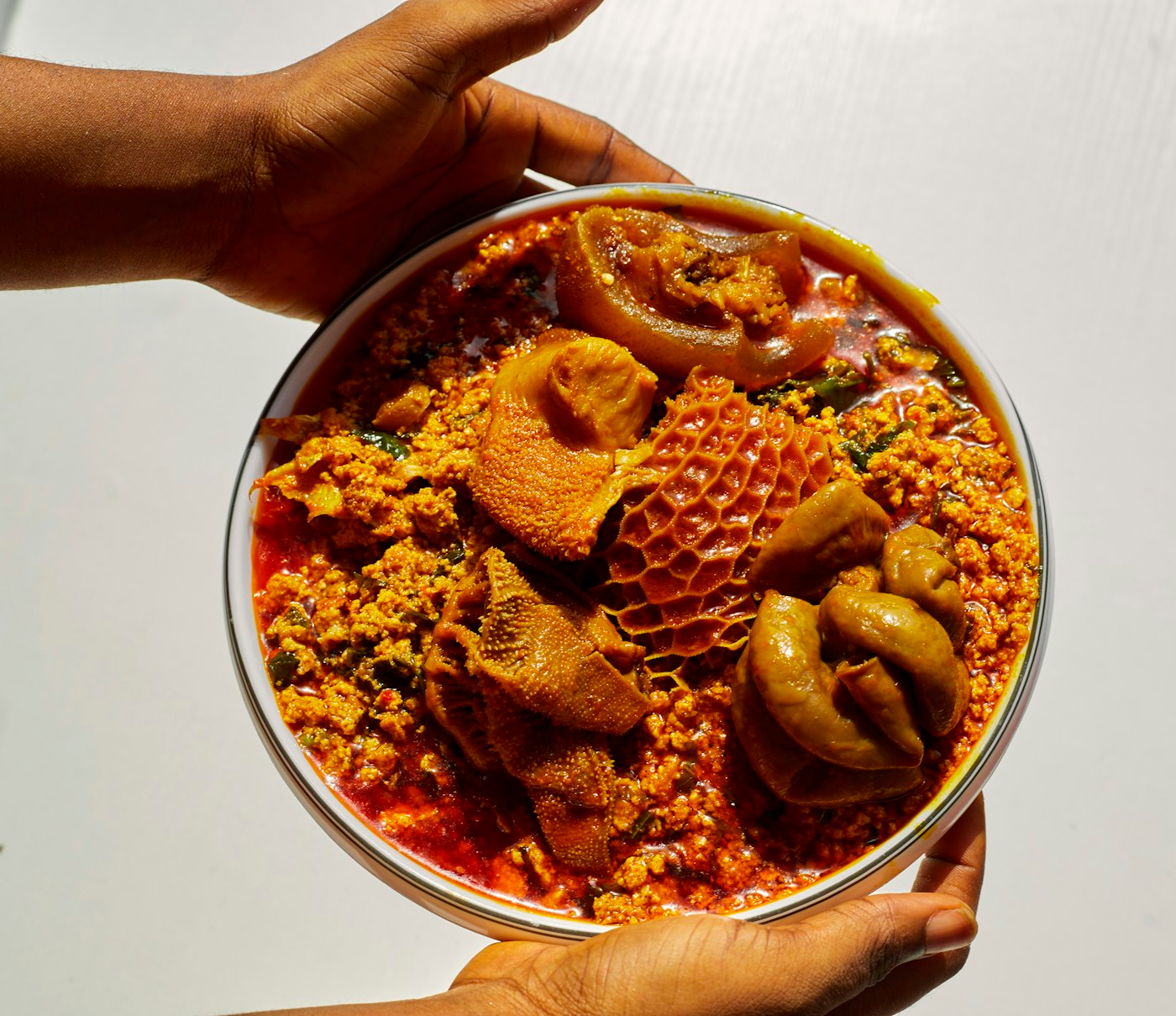 A bowl of egusi soup loaded with assorted meats